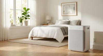 A Coway air purifier in a bright, clean bedroom with morning light, designed for allergy relief.