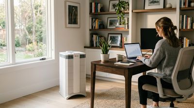 The IQAir HealthPro Plus air purifier in a modern, sparse home office setting.